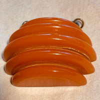 Carved Orange Bakelite Pendant