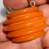 Carved Orange Bakelite Pendant