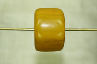 Pale yellow amber cylindrical bead