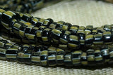 Small Black Seed beads with white and green stripes